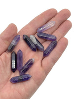 Amethyst terminated carved point gemstone, 33mm, with purple crystal structure and polished faceted surface from GemstoneGO.