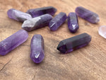 Amethyst terminated carved point gemstone from GemstoneGO, 33mm, showcasing a purple amethyst crystal with detailed carvings.
