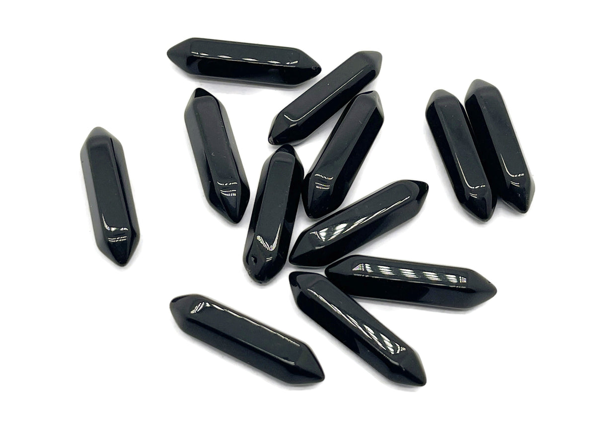 Obsidian terminated carved point gemstone from GemstoneGO, 33mm in length, showing polished black stone with carved details.