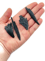 Raw black kyanite gemstone fan shape from GemstoneGO, showcasing natural dark blue-black crystal with fibrous texture.