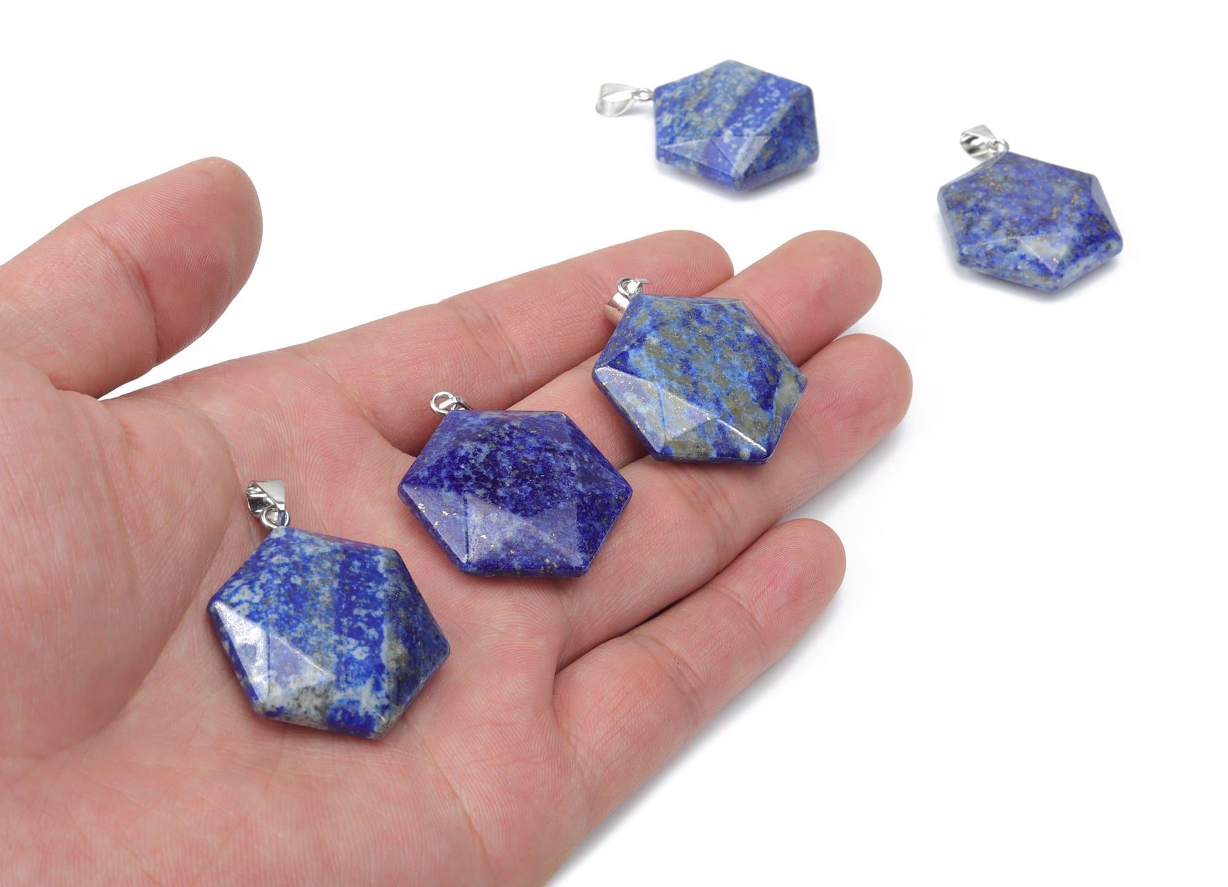Lapis Lazuli star-shaped Merkaba pendant from GemstoneGO, used for jewelry making, with deep blue and gold speckled gemstone.