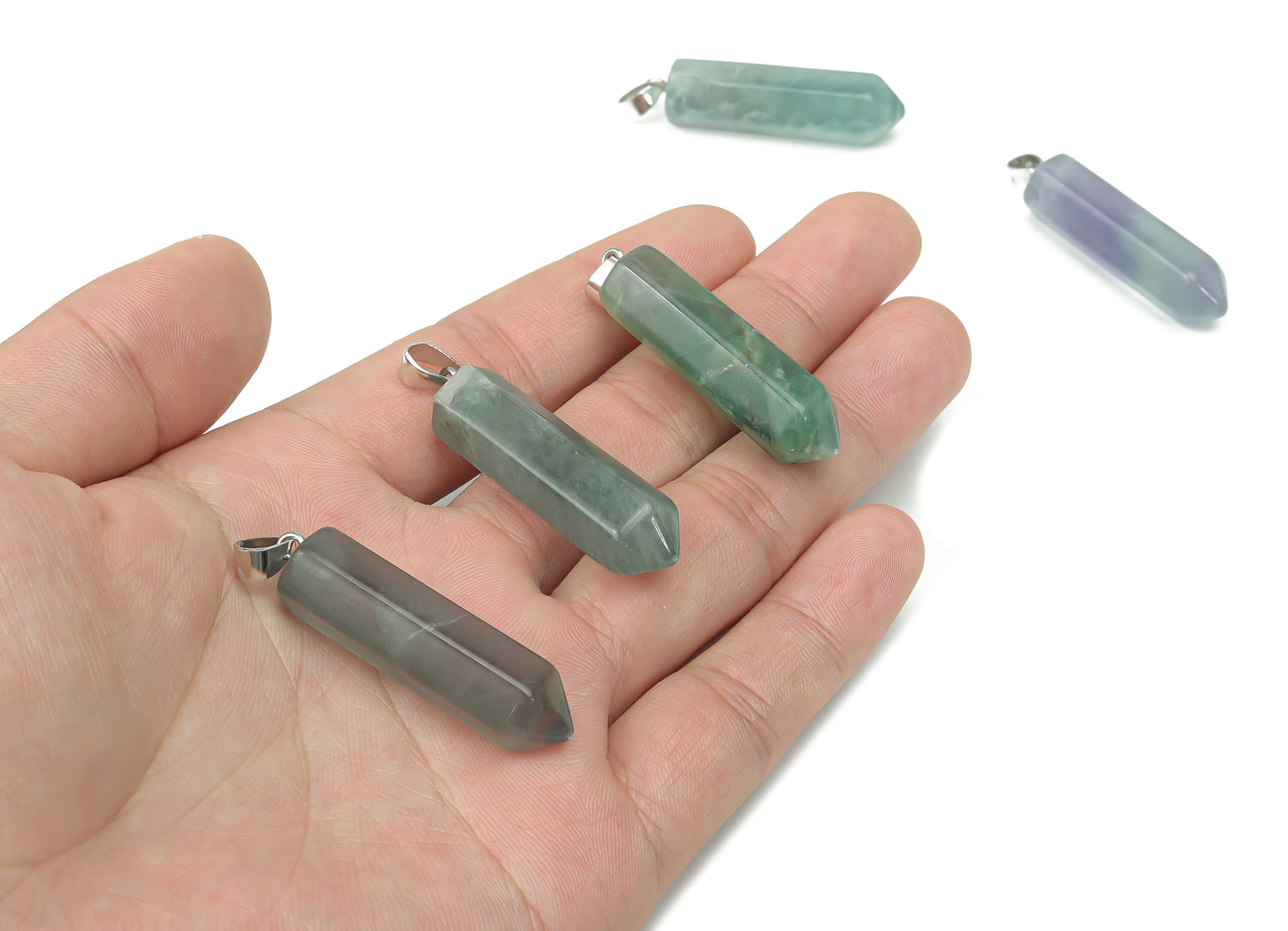 Purple fluorite point crystal pendant from GemstoneGO, ideal for jewelry making, showing a polished mineral with natural banding.