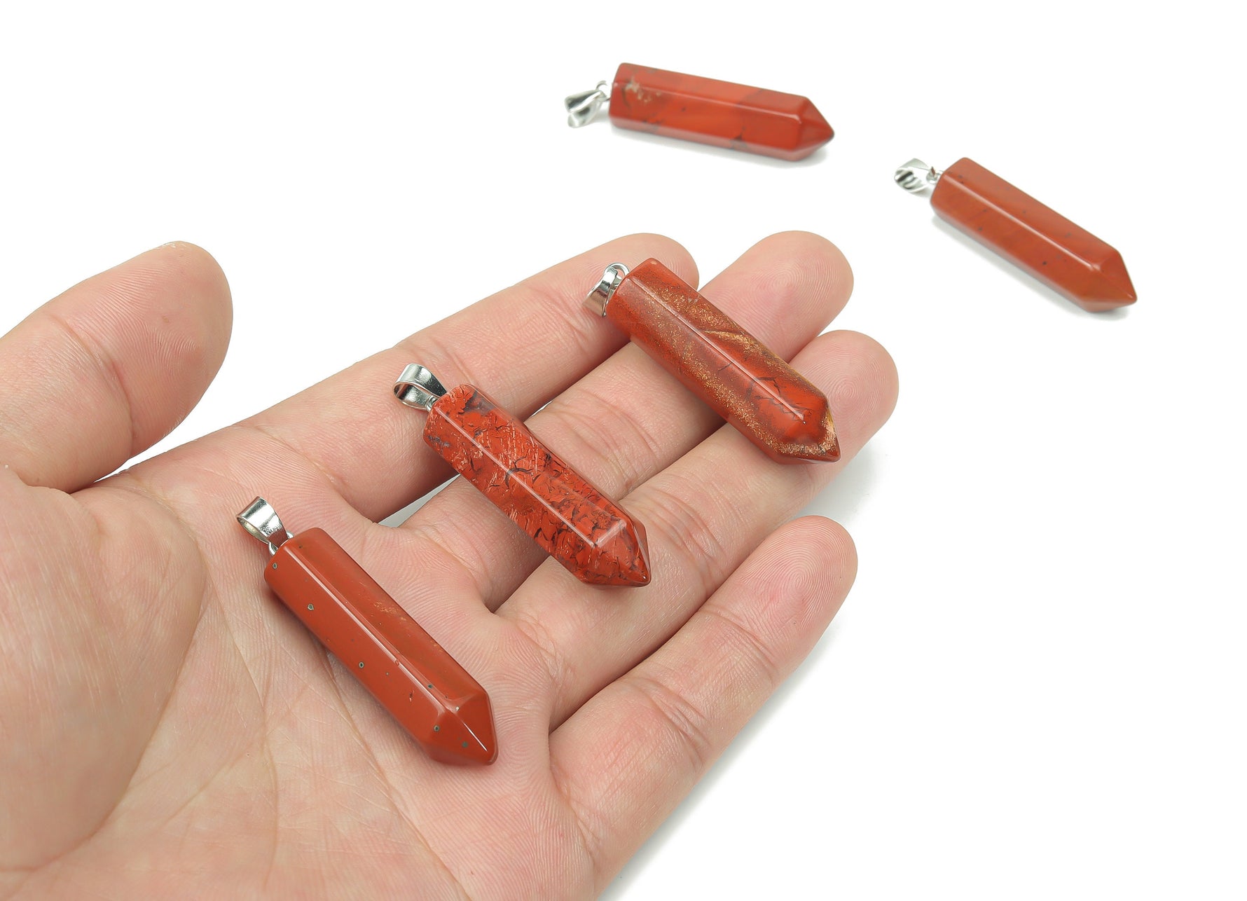 Red Jasper point crystal pendant from GemstoneGO, showcasing a polished red jasper stone with natural patterns and a pointed shape.