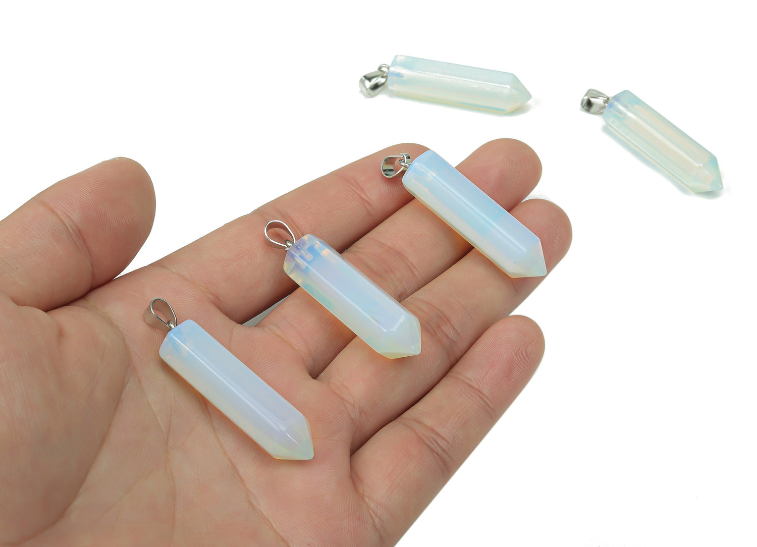 Opalite point crystal pendant from GemstoneGO, ideal for jewelry making, showcasing a smooth, translucent gemstone with a pointed tip.