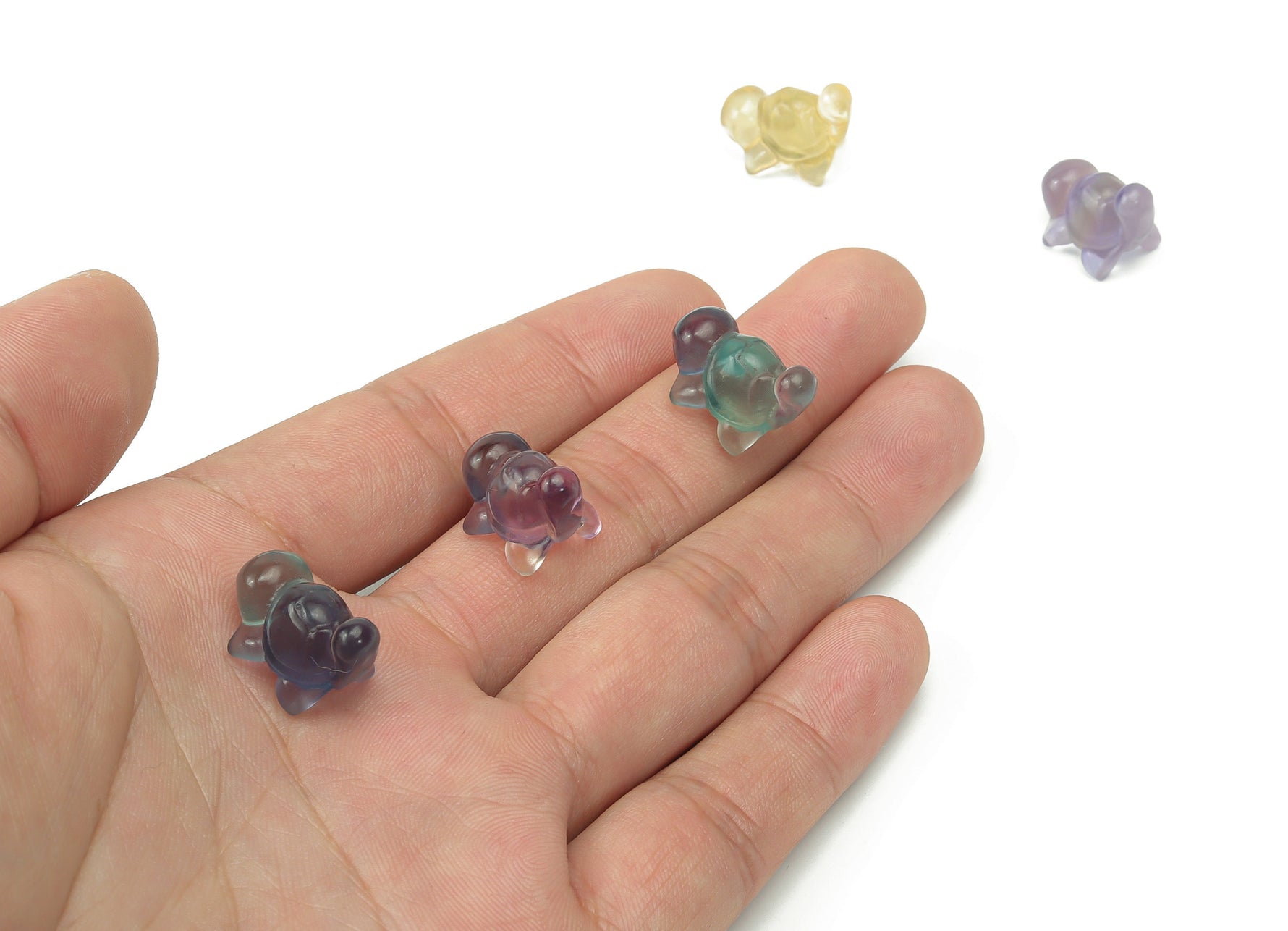 Fluorite tortoise carving gemstone from GemstoneGO, showing vibrant purple and green hues with detailed carved shell and features.
