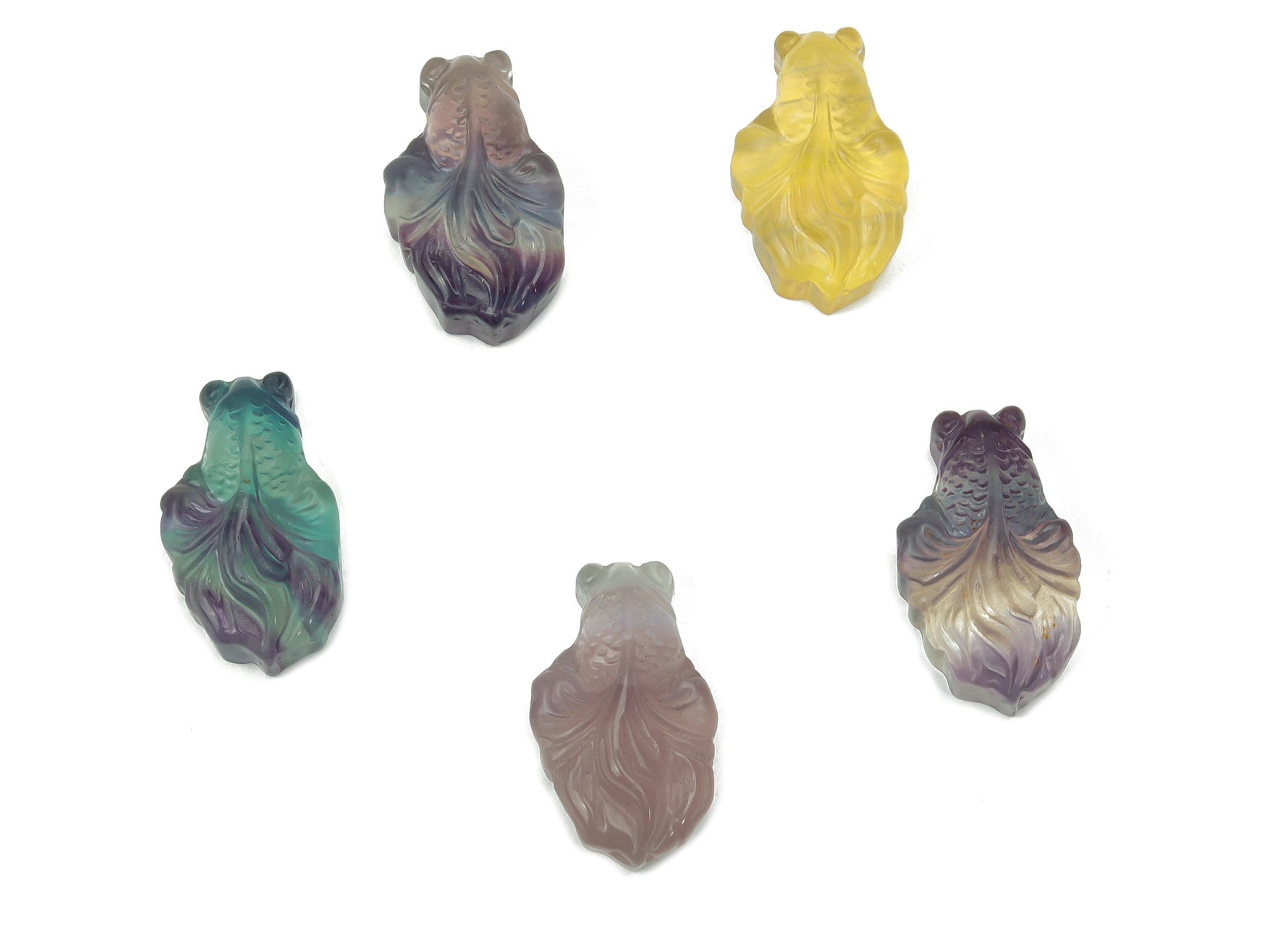 Colorful fluorite gemstone carved into an aquarium fish shape, showcasing vibrant hues and intricate details.