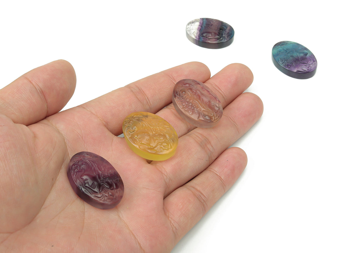 Fluorite lady portrait gemstone carving by GemstoneGO showing detailed colorful gemstone art on a polished surface.