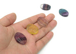 Fluorite lady portrait gemstone carving by GemstoneGO showing detailed colorful gemstone art on a polished surface.