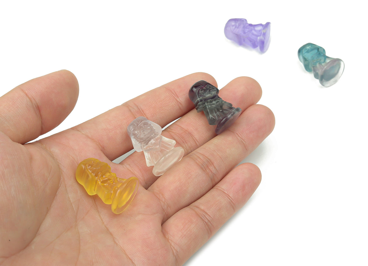 Fluorite Darth Wader gemstone carving by GemstoneGO, featuring a detailed Star Wars-themed character in vibrant purple and green hues.