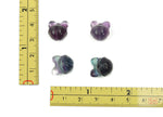Polished fluorite crystal gemstone carving with vibrant purple and green hues, showcasing intricate natural patterns and smooth finish.