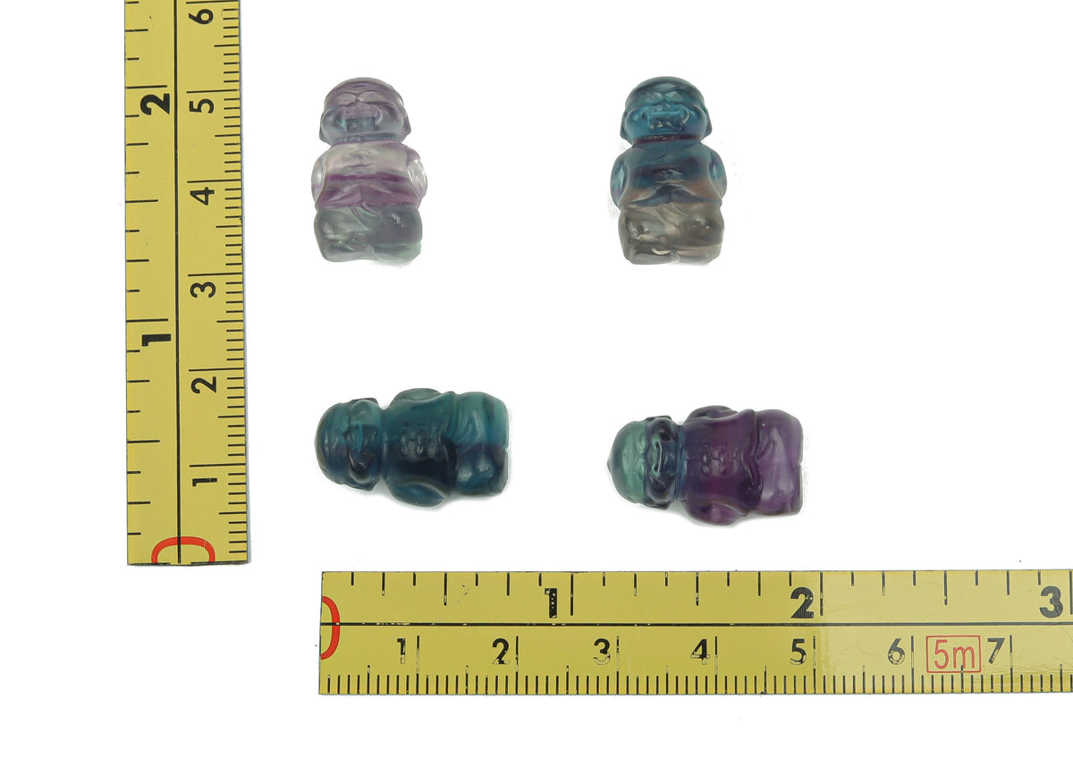 Small fluorite crystal carving gemstone from GemstoneGO, showcasing vibrant purple and green hues with intricate natural details.