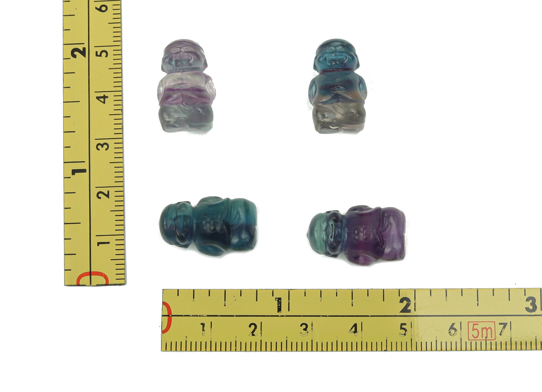 Small fluorite crystal carving gemstone from GemstoneGO, showcasing vibrant purple and green hues with intricate natural details.