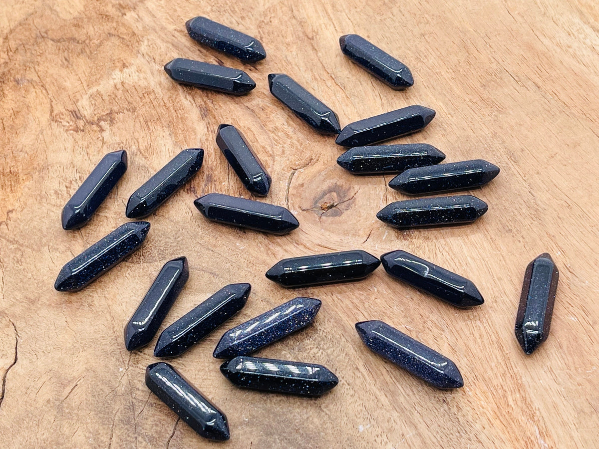Blue Goldstone terminated carved point gemstone, 33mm, showcasing a polished, faceted crystal with vibrant blue and gold shimmer.