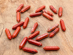 Red Jasper terminated carved point gemstone from GemstoneGO, 33mm, showcasing polished red jasper with natural carved details.