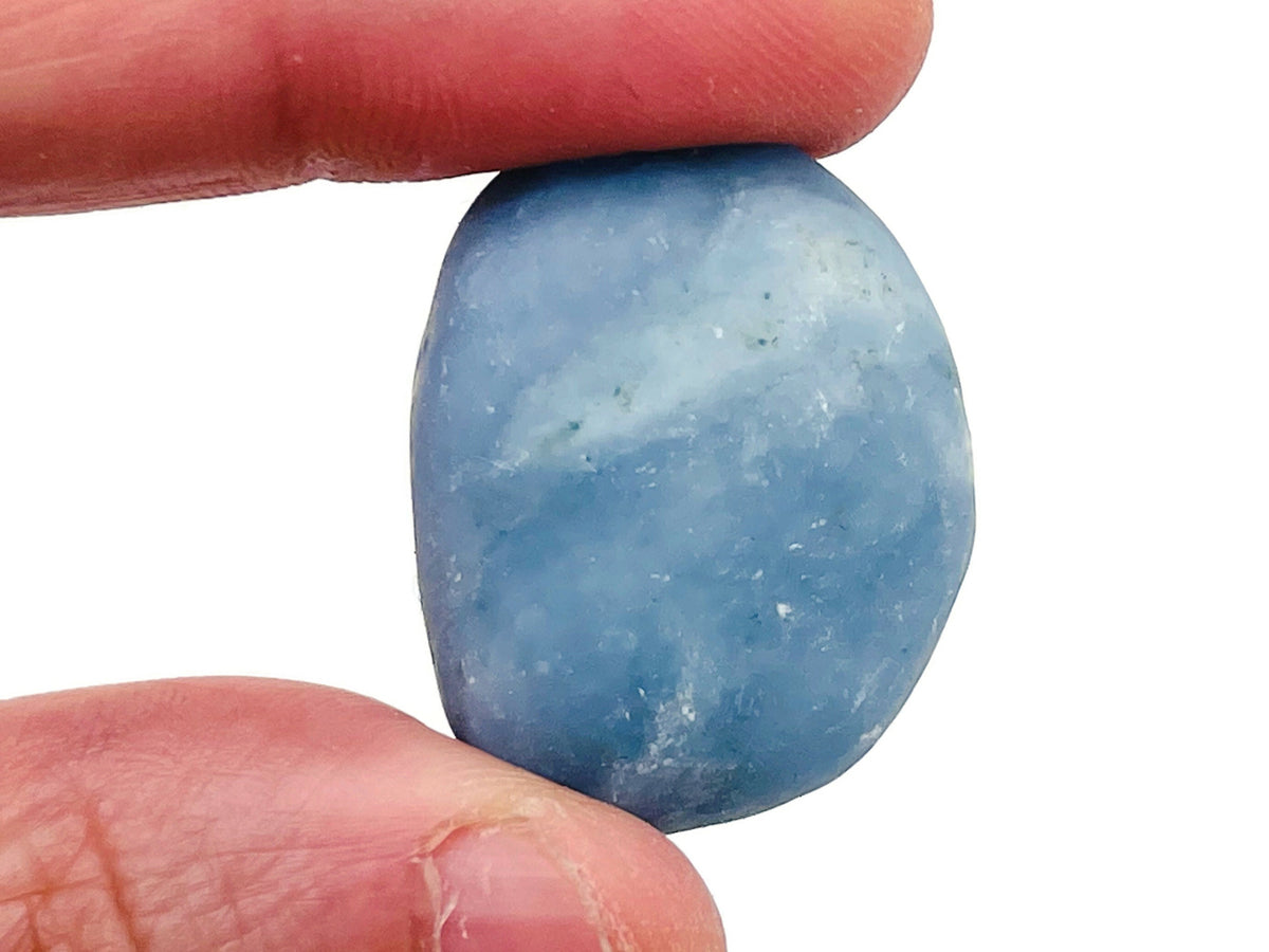 Angelite tumbled stone from GemstoneGO, smooth pale blue mineral with gentle natural inclusions and a polished finish.