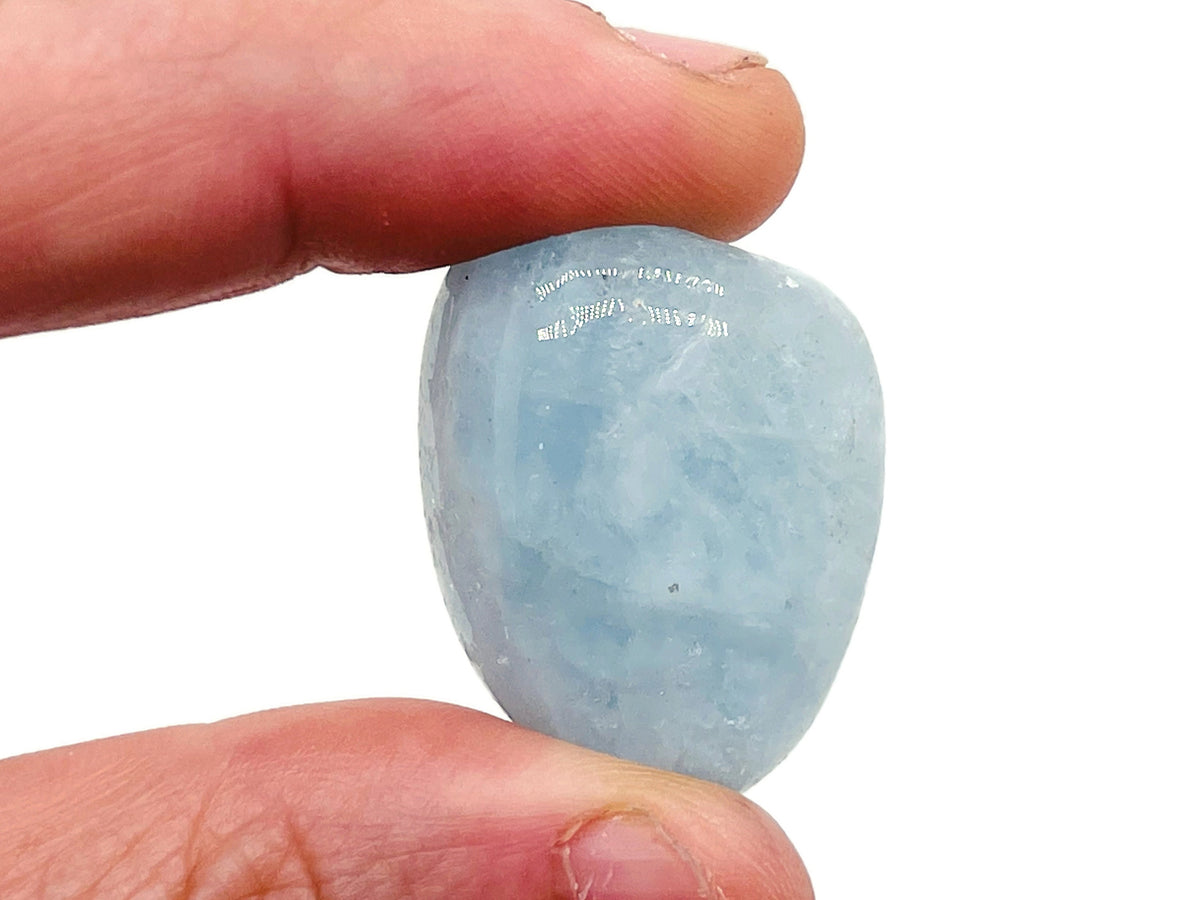 Aquamarine tumbled gemstone from GemstoneGO, smooth blue-green mineral with polished surface, used for jewelry or meditation.