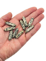 Dalmatian Jasper terminated carved point gemstone from GemstoneGO, 33mm, showing distinctive black spots on light stone with polished surface.