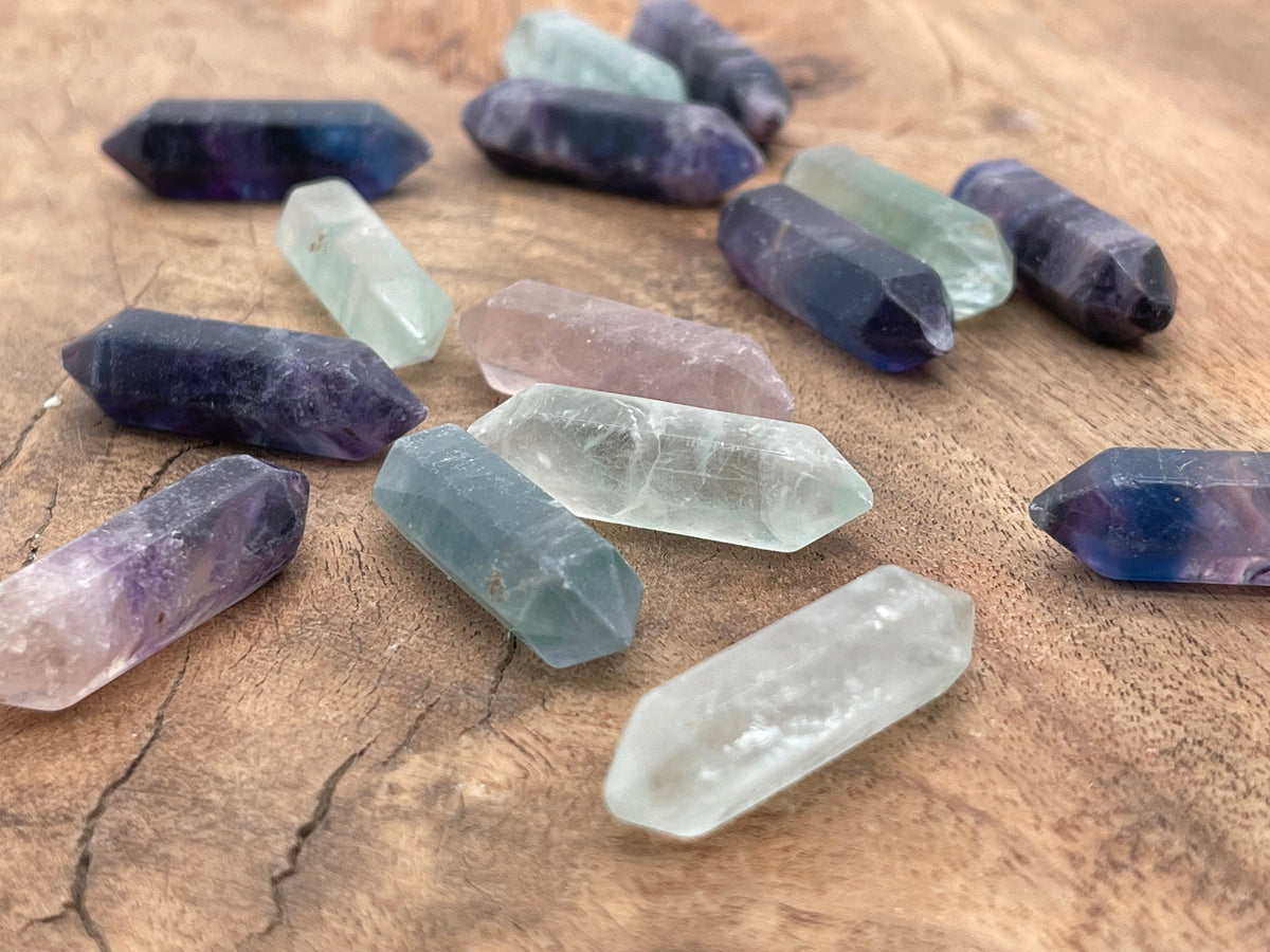 33mm fluorite terminated carved point gemstone from GemstoneGO, showcasing vibrant green and purple mineral layers.