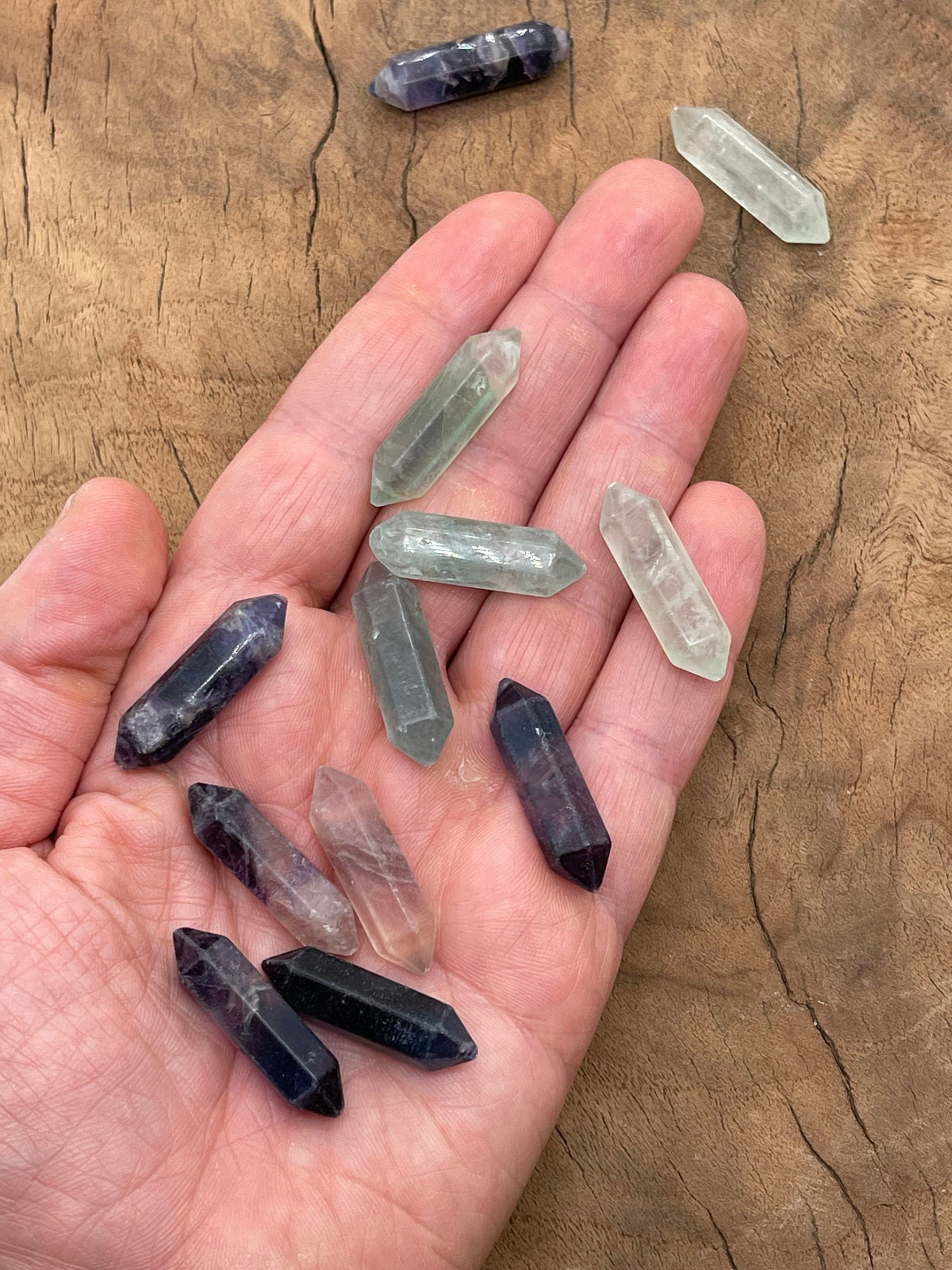 Carved fluorite terminated point gemstone from GemstoneGO, 33mm, displaying vibrant purple and green hues with natural banding.