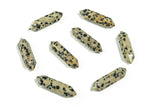 Dalmatian Jasper terminated carved point gemstone from GemstoneGO, 33mm, showcasing black spots on a cream-colored stone.