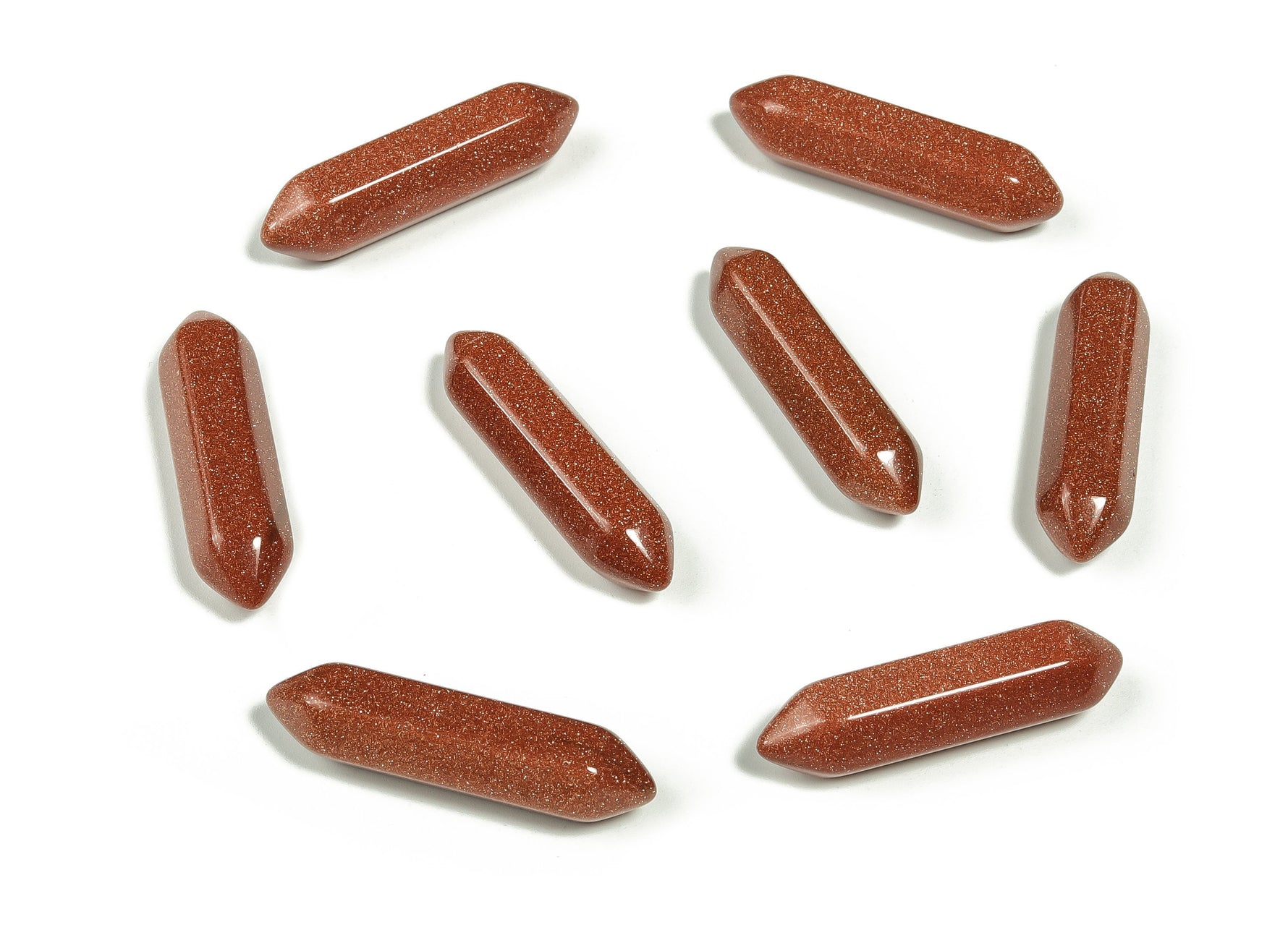 Golden Goldstone terminated carved point gemstone, 33mm, from GemstoneGO, featuring intricate carving and a shiny, reflective surface.