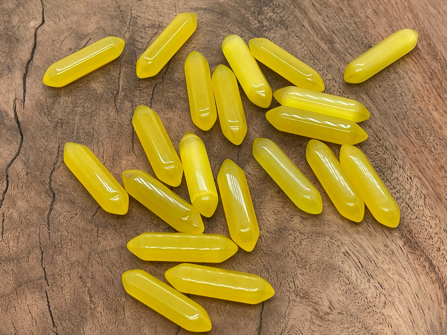Yellow Cats Eye gemstone carved point, 33mm, from GemstoneGO, featuring a polished, carved termination with vibrant yellow color.