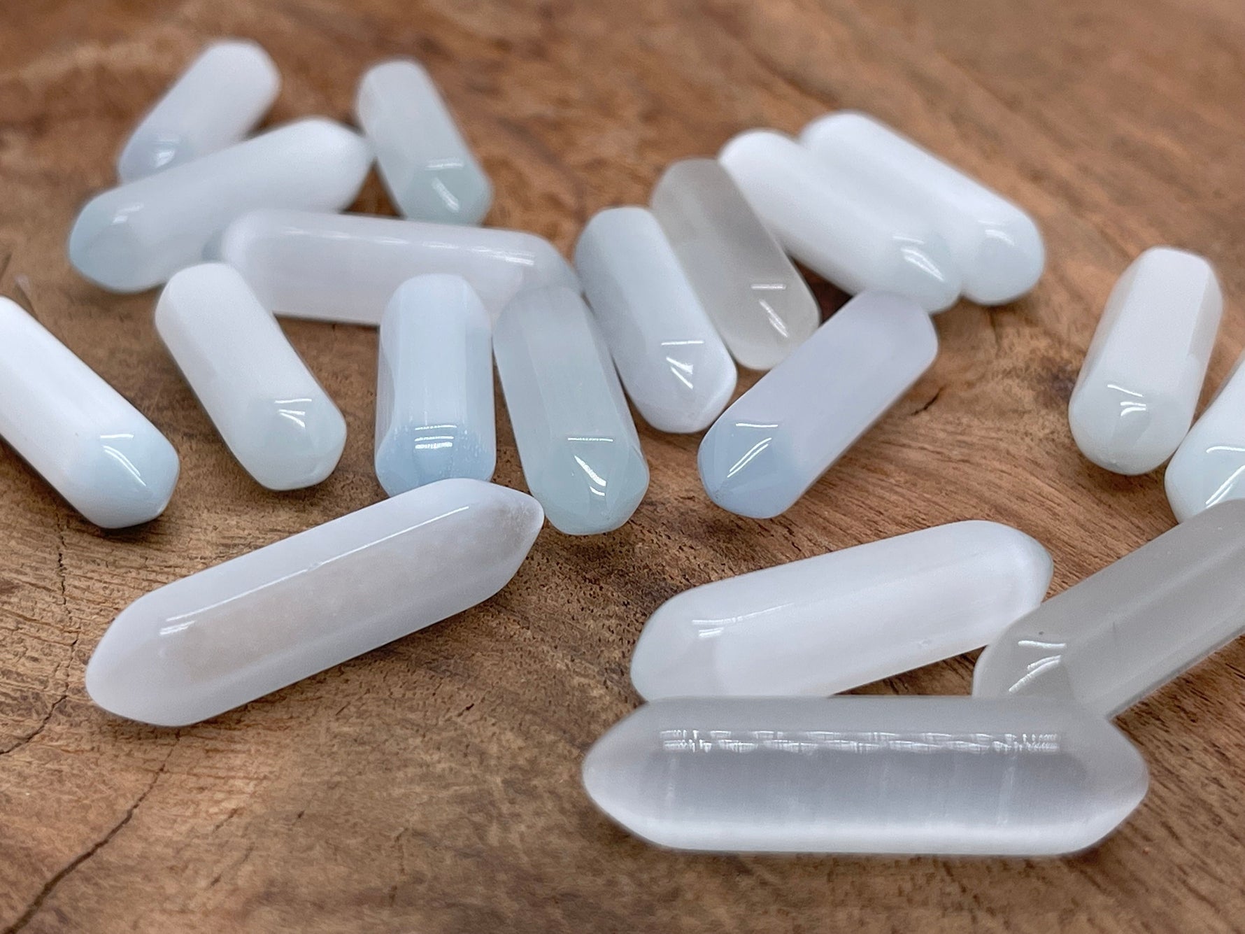 White cats eye gemstone carved point, 33mm, from GemstoneGO featuring a polished, carved cat's eye effect in a white tone.