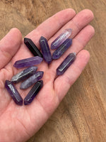 Amethyst terminated carved point gemstone, 33mm, from GemstoneGO, showcasing purple crystal with natural facets and polished tip.