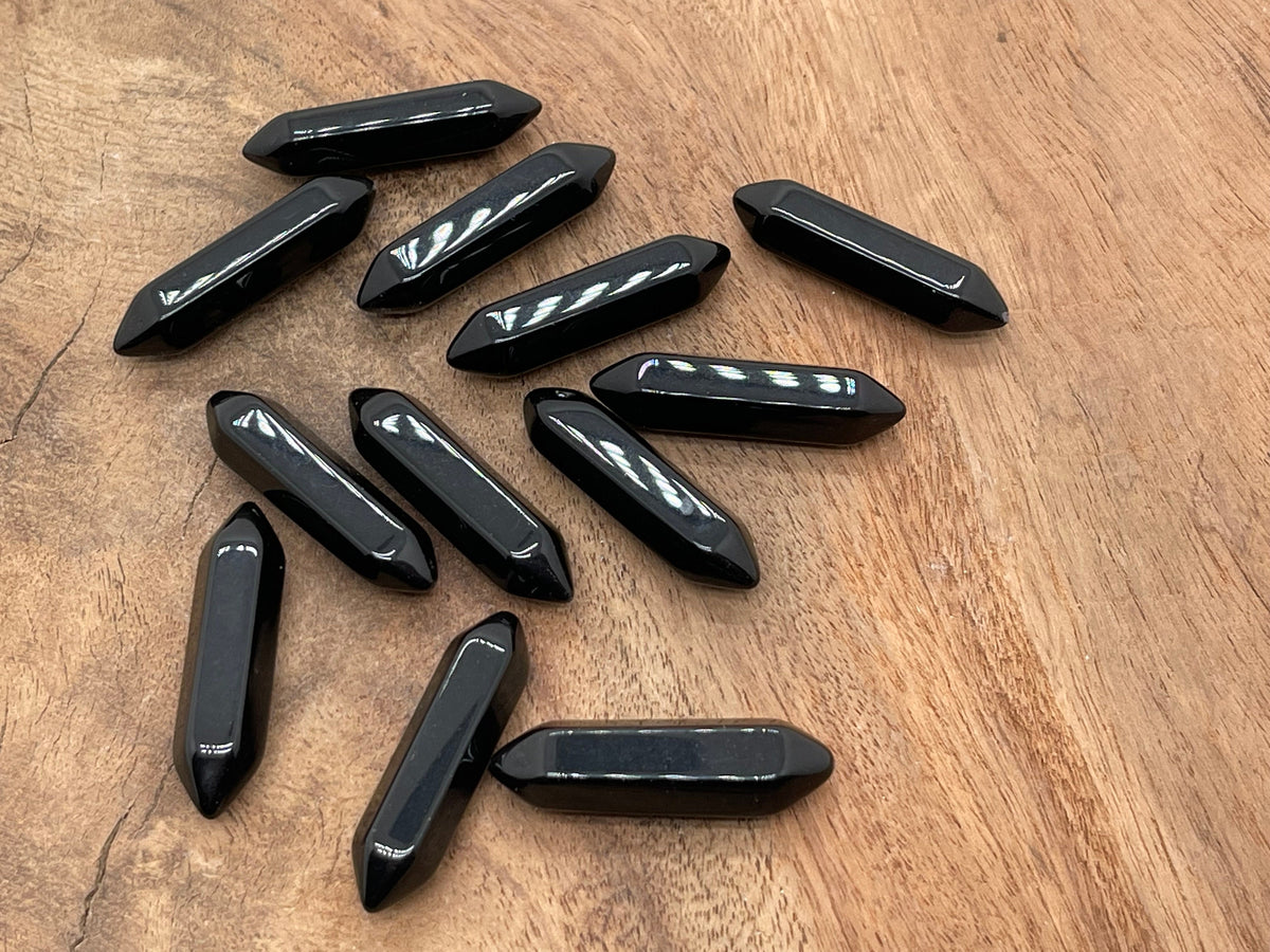 Obsidian terminated carved point gemstone from GemstoneGO, 33mm, with intricate carving and polished surface.