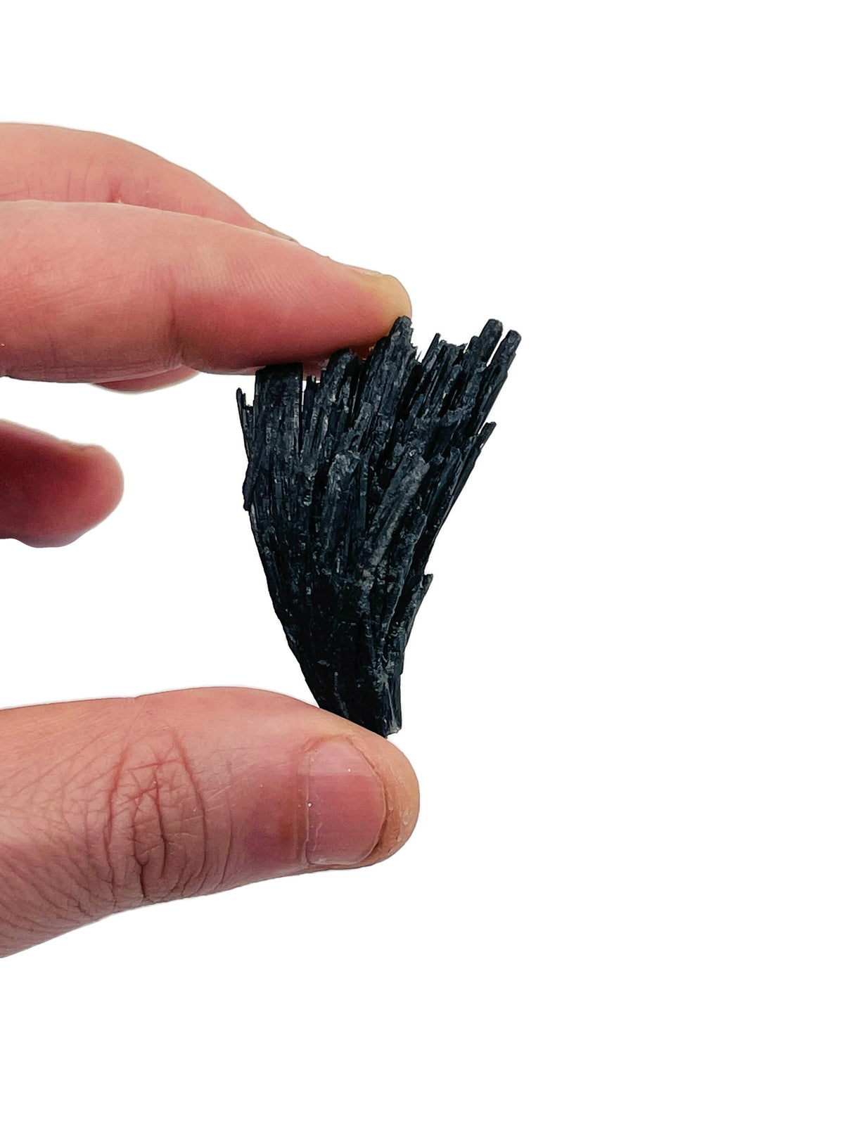 Raw black kyanite fan gemstone from GemstoneGO, showcasing natural, unpolished black stone with fan shape and textured surface.