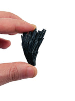 Raw black kyanite fan gemstone from GemstoneGO, showcasing natural, unpolished black stone with fan shape and textured surface.