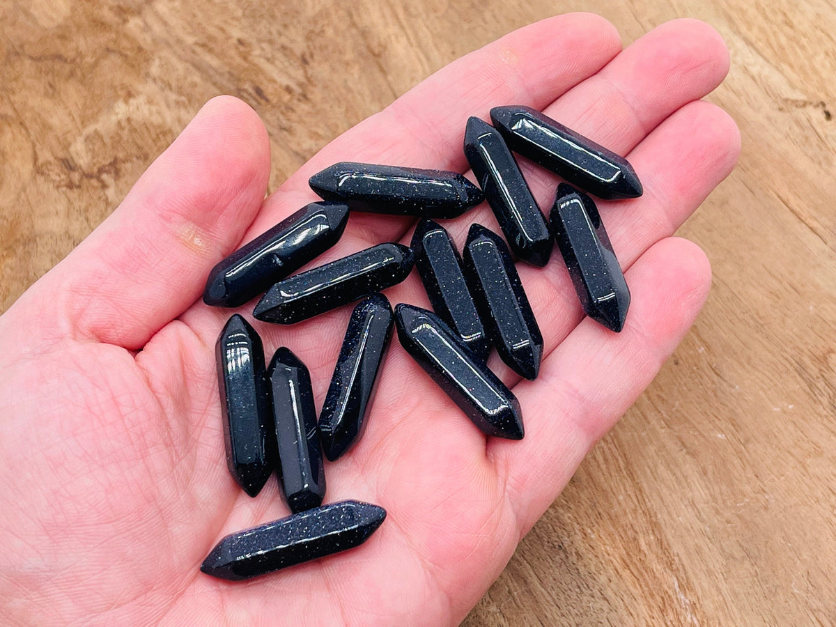 Blue Goldstone terminated carved point gemstone, 33mm, with a polished, faceted surface and pointed tip, from GemstoneGO.