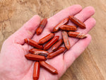 Red Jasper terminated carved point gemstone, 33mm, from GemstoneGO, showing detailed carving and vibrant red color.