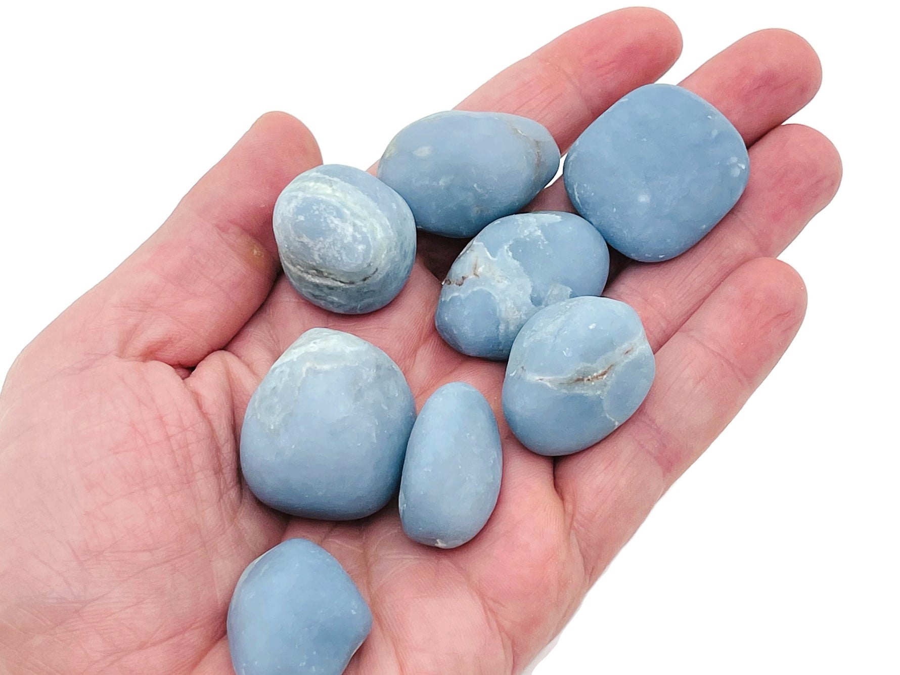 Angelite tumbled stone from GemstoneGO, smooth light blue gemstone with natural veining, used for meditation and healing.