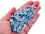 Semi-tumbled celestite crystal chips in 5-10mm size, natural gemstone bulk stones from GemstoneGO, showcasing blue, pearly mineral pieces.