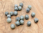 Mini 18mm Labradorite Saturn crystal carved gemstone from GemstoneGO, showcasing its planetary design and iridescent labradorite surface.