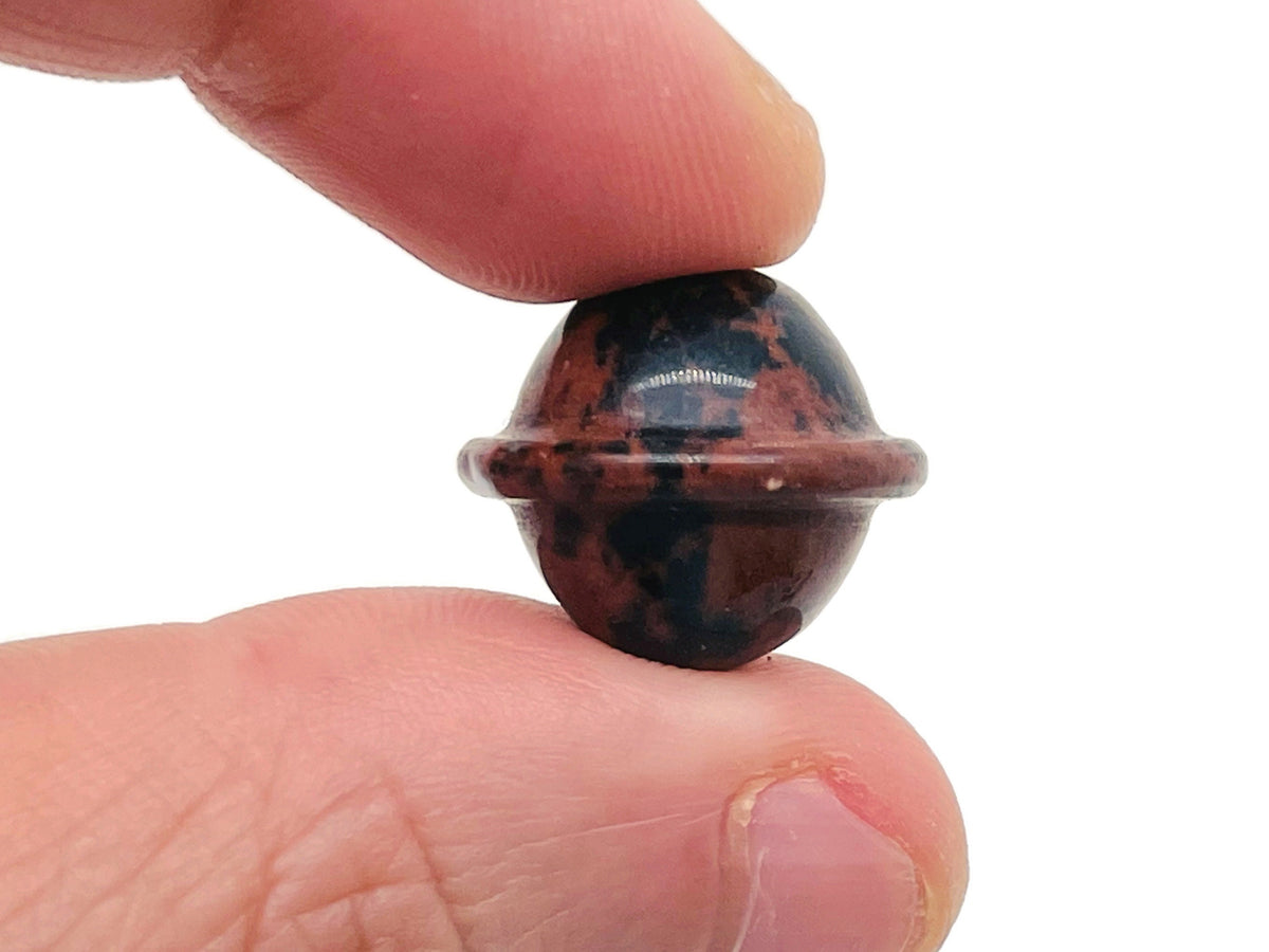 Mini mahogany obsidian Saturn gemstone carved as a planet, 18mm, from GemstoneGO, detailed planetary design with rich color and texture.