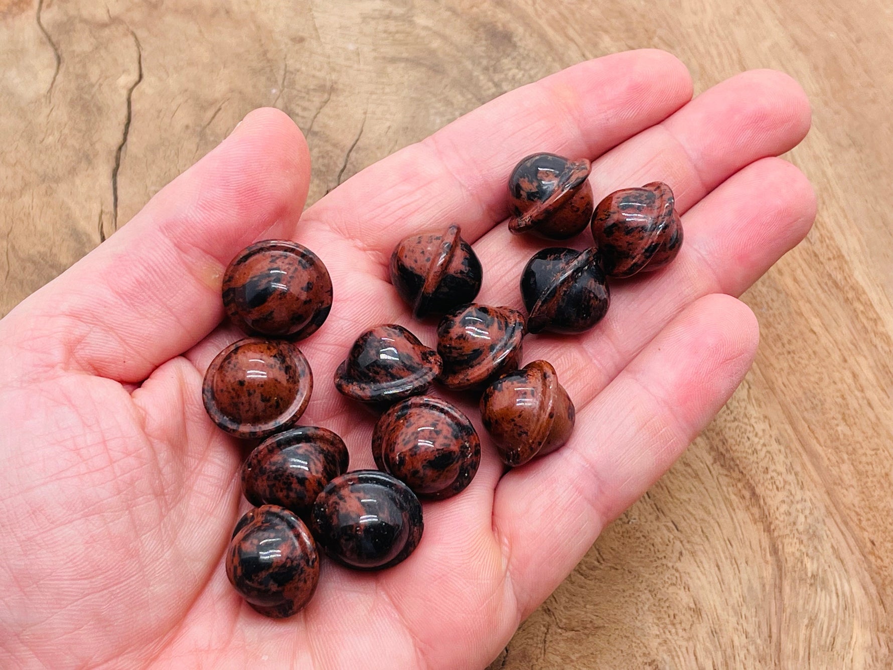 Mini mahogany obsidian Saturn crystal carved as a gemstone planet, 18mm gemstone with detailed planetary features.