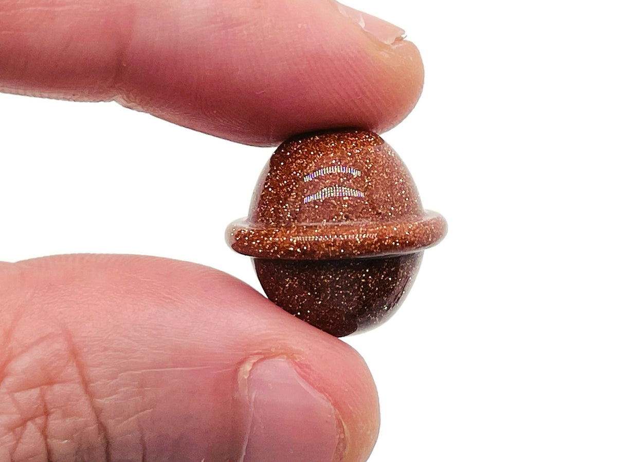 Goldstone Saturn-shaped carved gemstone mini planet, 18mm size, from GemstoneGO, showcasing detailed planetary design and rich golden color.