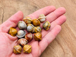 Mini 18mm Crazy Lace Agate Saturn crystal gemstone carved as a planet, showcasing vibrant banding and intricate details.
