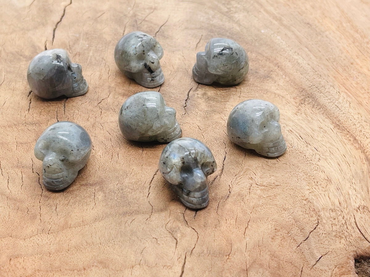 Labradorite skull carved gemstone, 25mm, with iridescent flashes, crafted by GemstoneGO, detailed and polished for display.