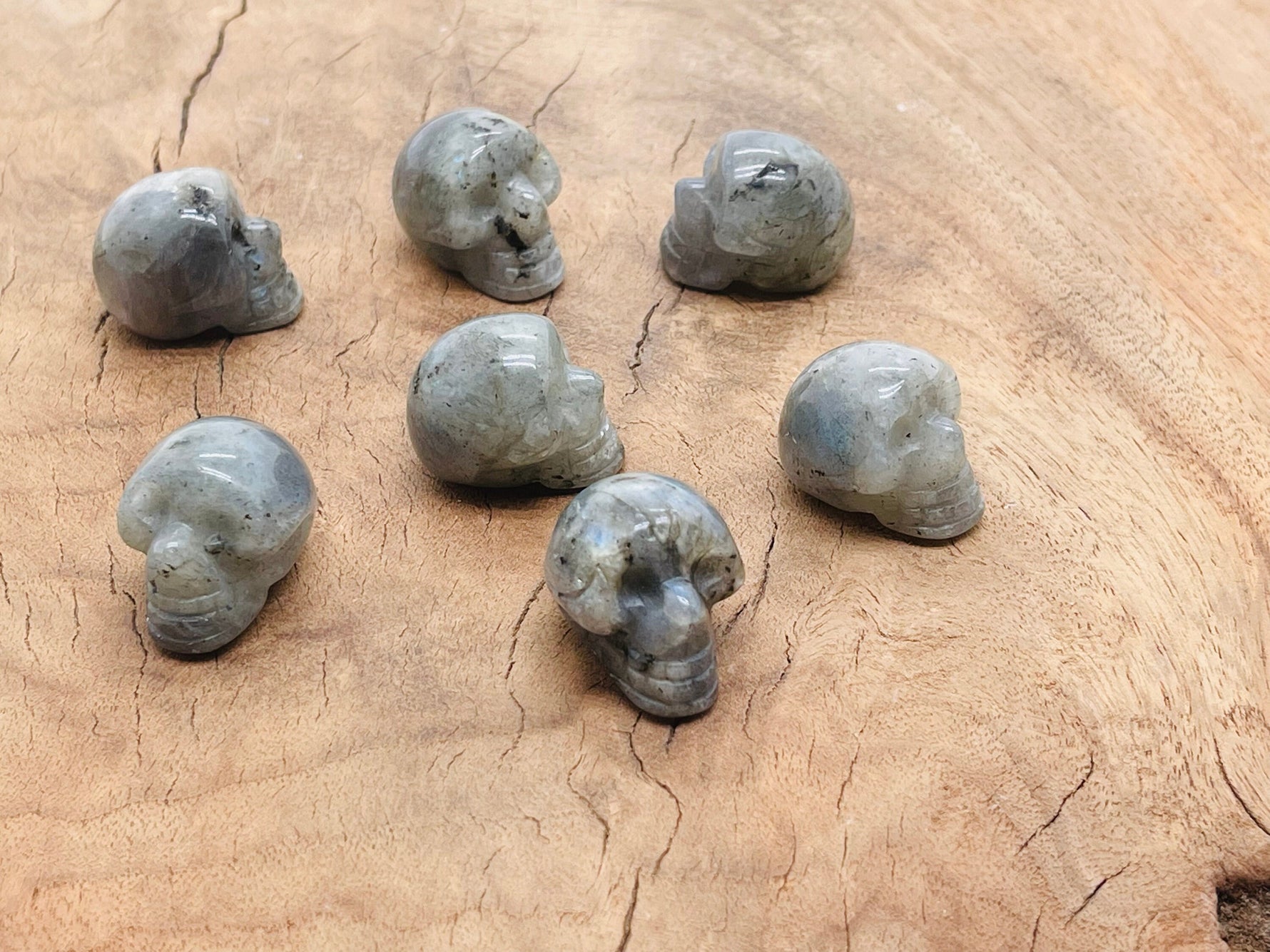 Labradorite skull carved gemstone, 25mm, with iridescent flashes, crafted by GemstoneGO, detailed and polished for display.