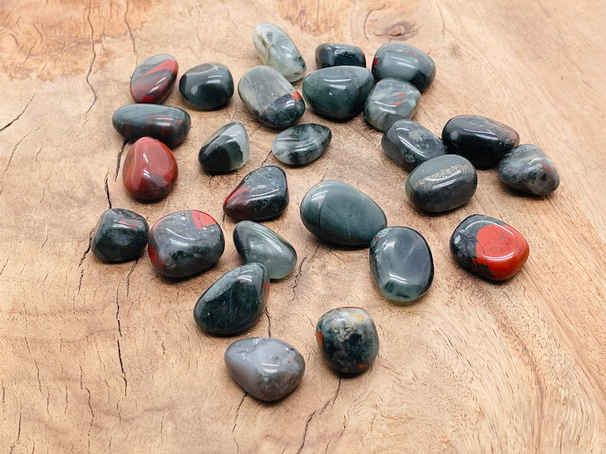 African Bloodstone tumbled stone from GemstoneGO, showcasing deep green and red mineral patterns with a smooth polished surface.