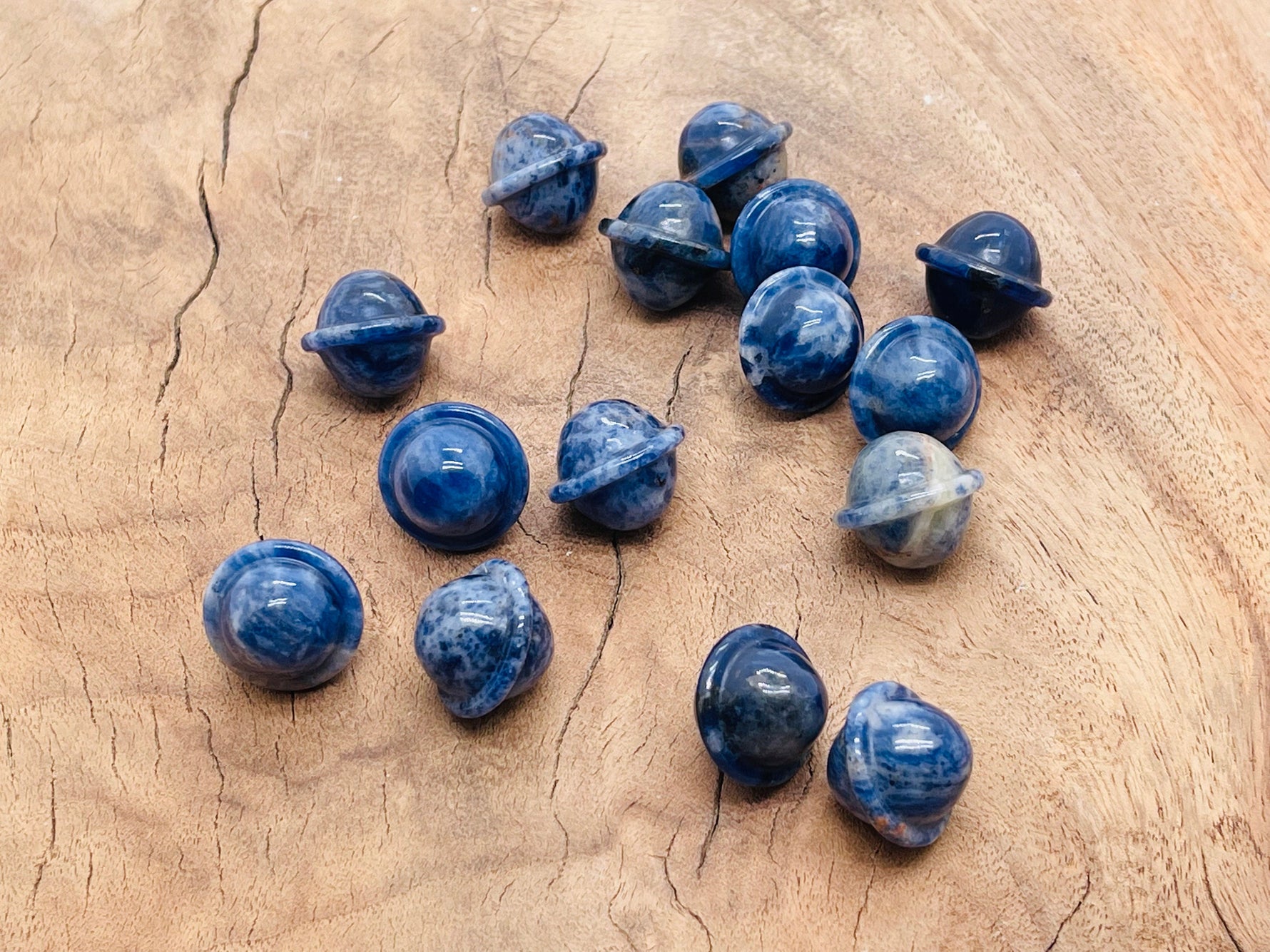 Mini Sodalite Saturn crystal gemstone carved as a planet, 18mm, showcasing deep blue color with white veining and smooth surface.