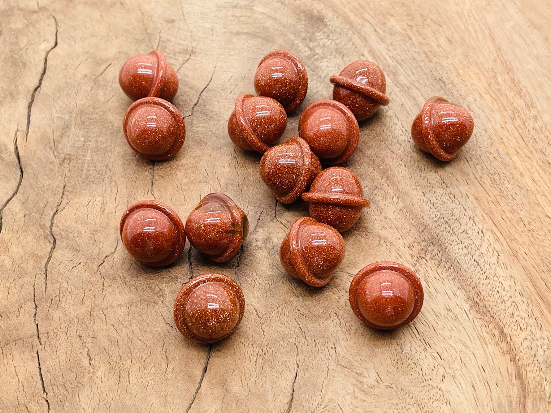 Goldstone Saturn-shaped crystal gemstone, 18mm mini planet carving by GemstoneGO, showcasing detailed planetary features and rich gold color.