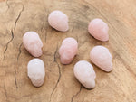 Rose quartz skull carved gemstone, 25mm, showcasing intricate details and smooth surface, from GemstoneGO.