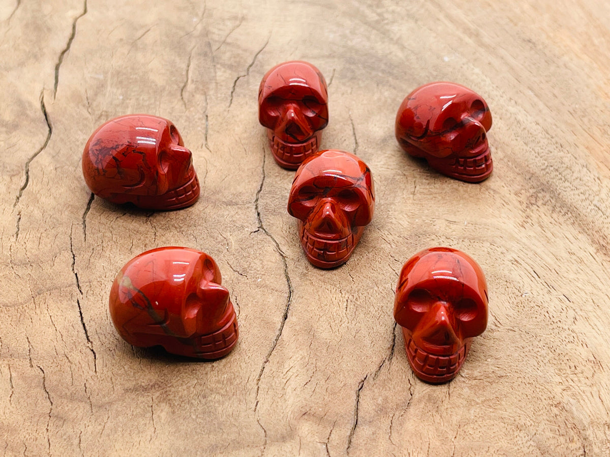 Red Jasper skull carved gemstone, 25mm, showing detailed craftsmanship and vibrant red color, perfect for gemstones and collectible carvings.