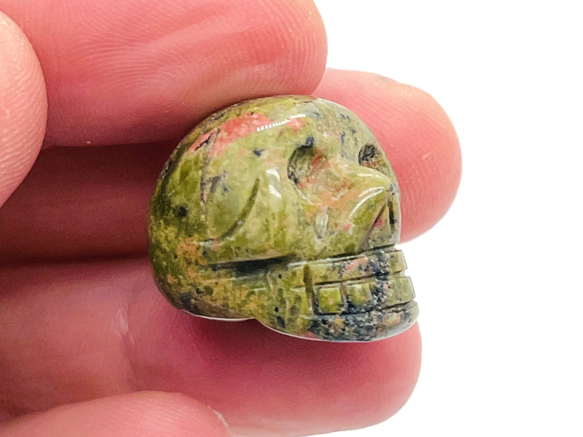 Unakite gemstone skull carved from 25mm unakite stone, showcasing green and pink mineral patterns, by GemstoneGO.