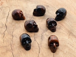 Mahogany Obsidian skull carved gemstone, 25mm, with detailed carving and polished finish from GemstoneGO.