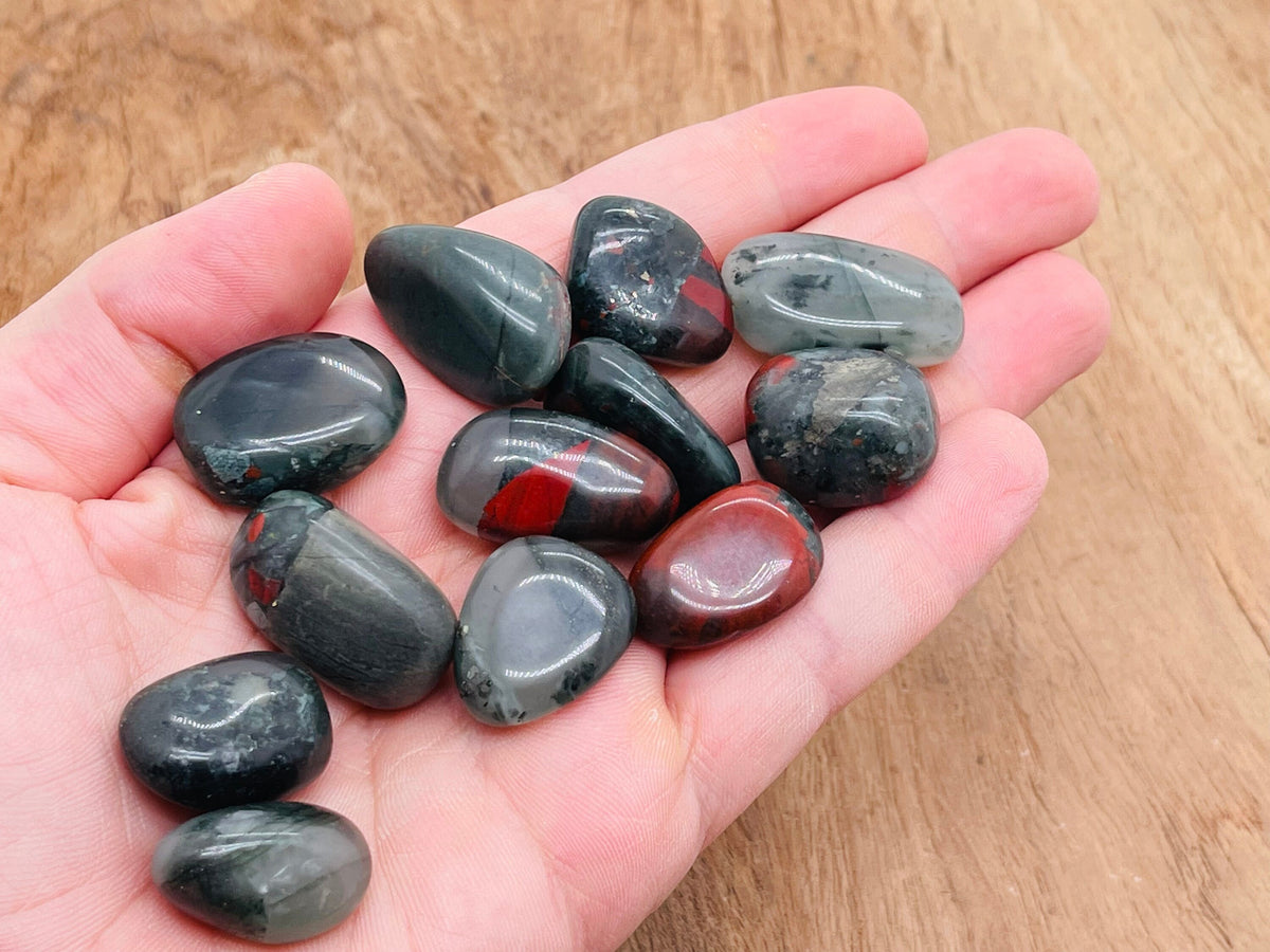 African Bloodstone tumbled gemstone from GemstoneGO, showing a polished dark green stone with red bloodstone inclusions.